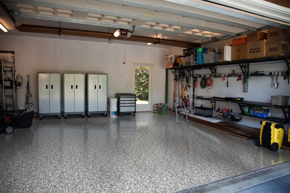 Organized two-car garage with a glossy black, gray and white flake floor