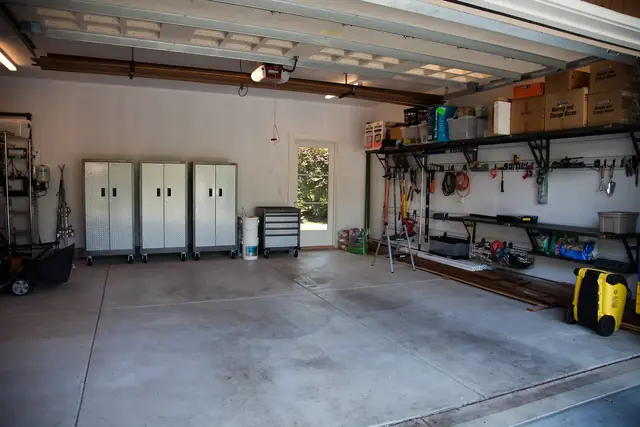 Two-car garage with a stained, bare concrete floor