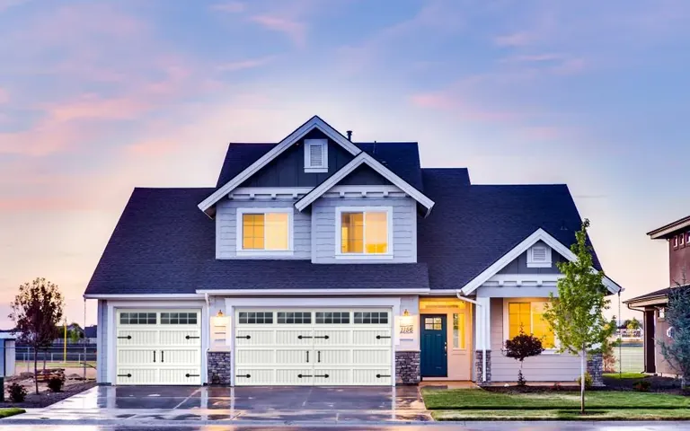 The same home with new white carriage-style garage doors, windows and hardware in the door visualizer