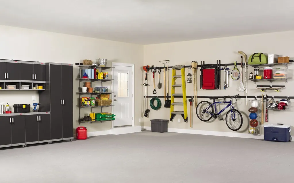 Bright, organized garage with cabinets, wall rails, shelving and a hanging bike