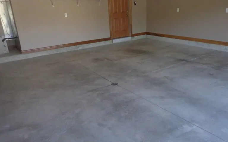 Two-car garage with a stained, bare concrete floor